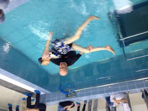 Passive practice of hydrotherapy, therapist with individual in water