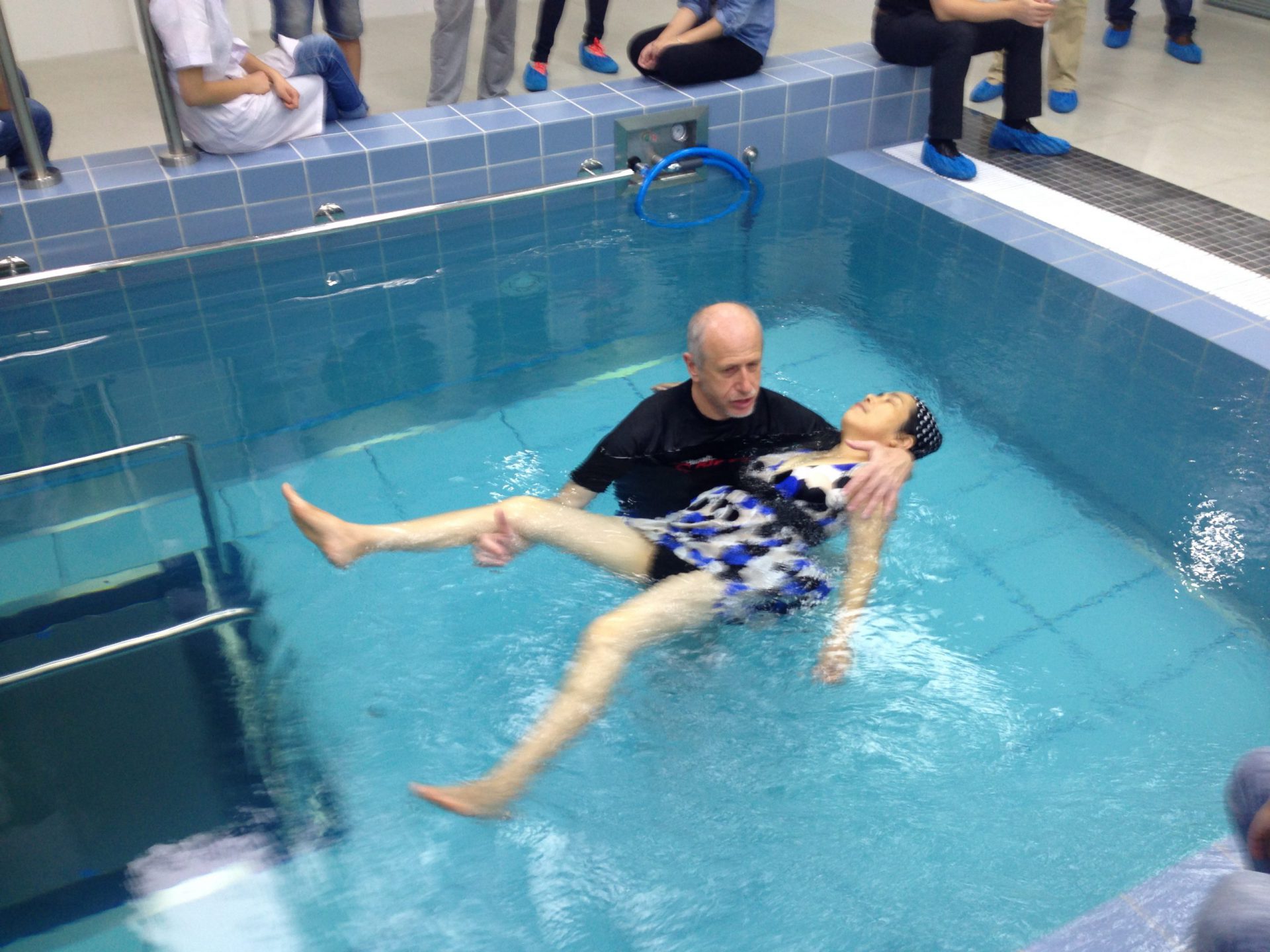 Passive practice of hydrotherapy, therapist with individual in water